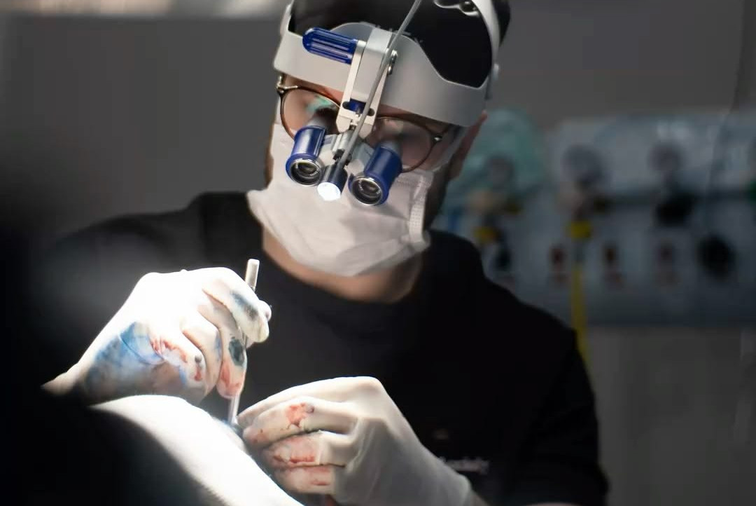 Eye-level view of a dentist using a microscope during root canal treatment