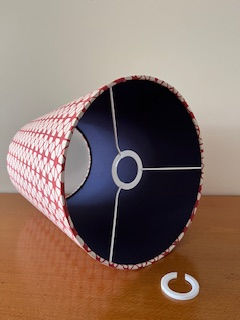 Thumbnail: Interior of red and white empire lampshade showing navy fabric lining.