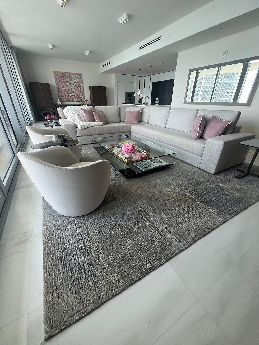 Eye-level view of a large rectangular rug under a living room sofa and chairs