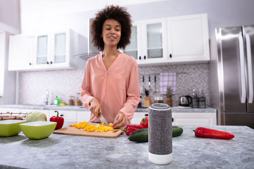 Wireless Speaker In Front Of Woman Cutting Vegetables On Chopping Board In The Kitchen.jpg