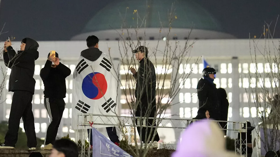 Young Koreans outside of South Korea's parliment (Lee Jin Man/AP)