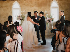 bride and groom in front of floral pillars