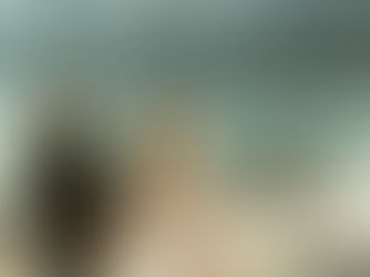 a couple walking in front of a lake getting married in wedding attire