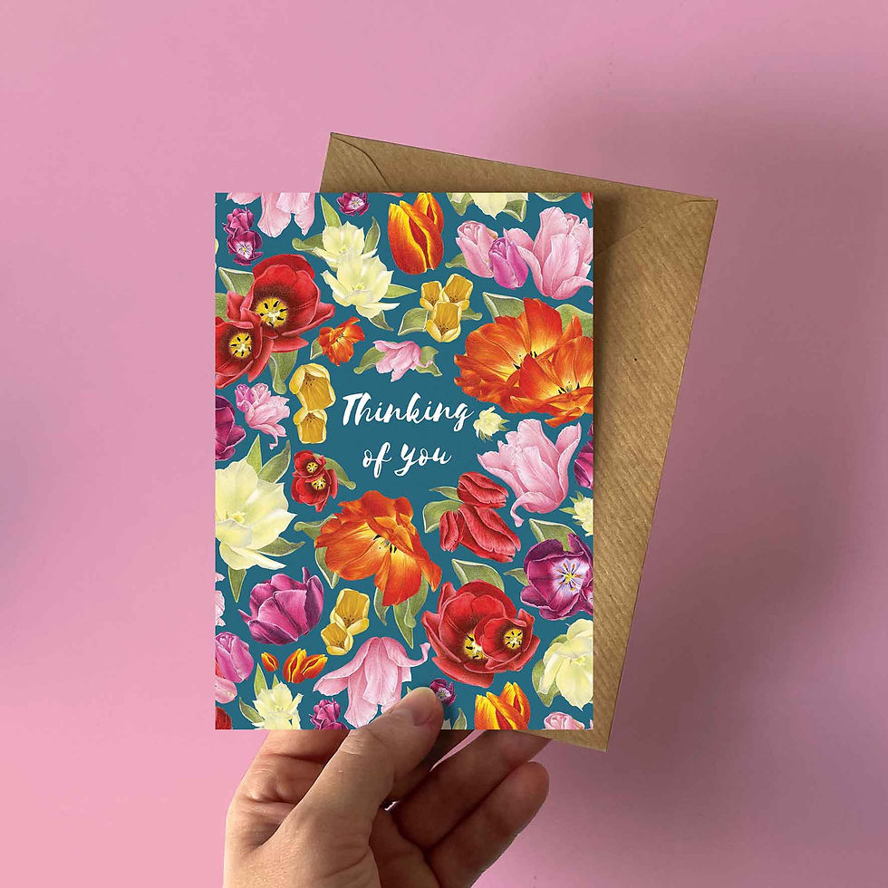 A6 card with colourful spring tulip design on teal background with white Thinking of You text, with Kraft envelope
