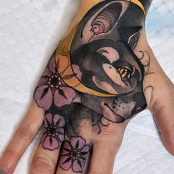 Hand tattoo featuring a cat, flowers and moon. Cover Up Tattoo Artist Near Me.