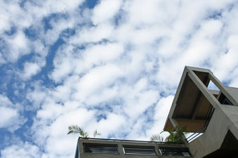 Rooftop view looking up toward the blue sky