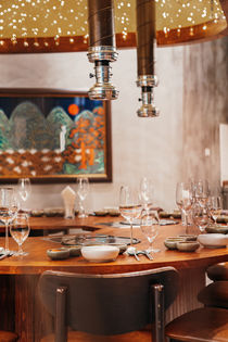 Private dining table with built-in Korean grill surrounded by timber panelling at Banjoo restaurant in Bangkok.