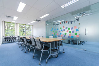 Conference room with colorful brainstorming wall and contemporary meeting furniture.
