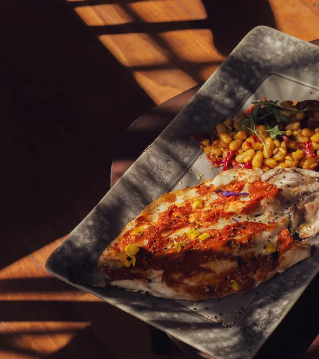 Charcoal-grilled fresh fish with white beans, red cabbage and pine nuts at Mandala Marrakech.