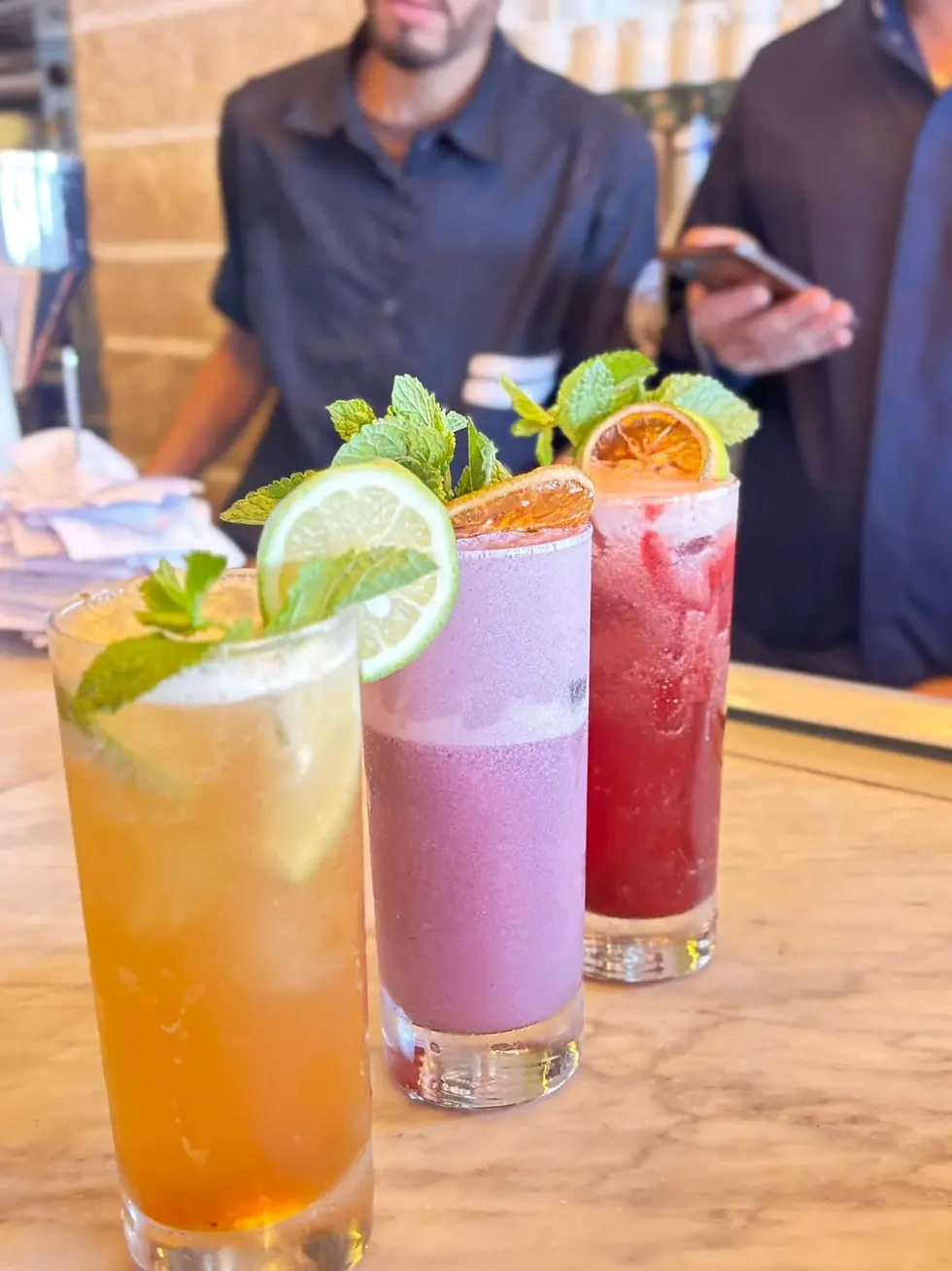 Colorful fresh fruit mocktails prepared on the counter at Café Vera in Essaouira.