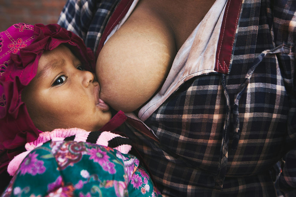 Close-up of infant breastfeeding