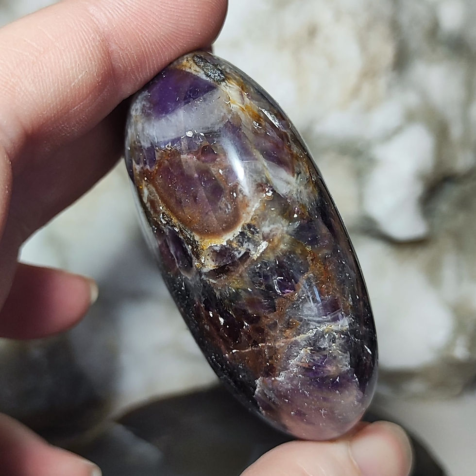 Thumbnail: amethyst pebble hand held side view