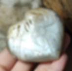 peach moonstone heart hand held side view