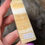 Thumbnail: banded orange calcite obelisk hand held side view