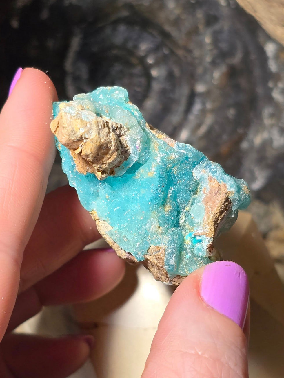 Thumbnail: rare blue hemimorphite hand held side view