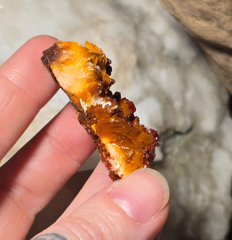 Thumbnail: vanadinite on baryte specimen hand held side view