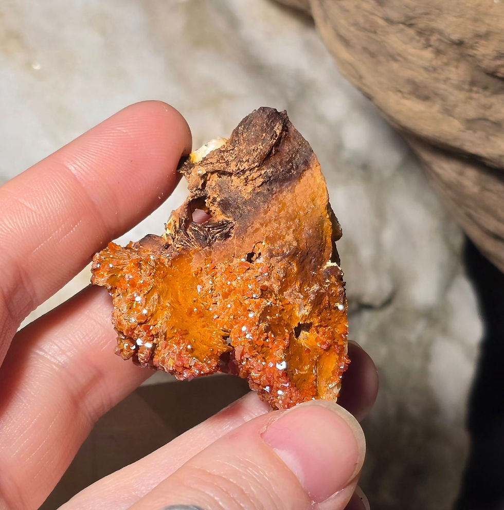 Thumbnail: vanadinite on baryte specimen hand held bottom view