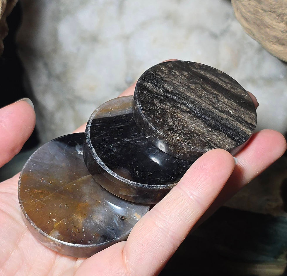 3 obsidian discs hand held