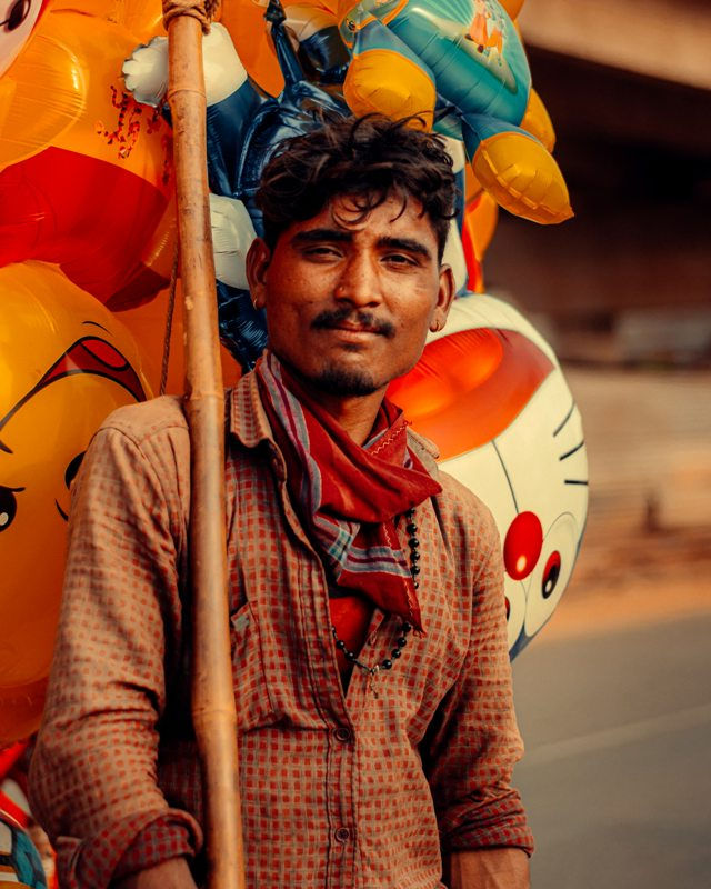 Poor man selling rubber toys to earn his livelihood