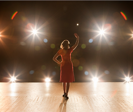 Woman on stage with bright lights