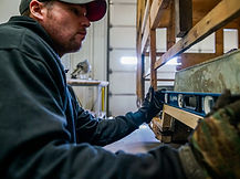 Action RV repair technician repairing RV