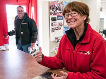 Debbie Cade talking to a customer at the front desk