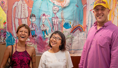 Local artists posing with Neil Smith. Their collaboratiev work is behind them.