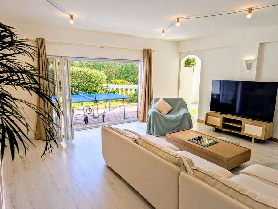 Windows open fully to the exterior from the living room