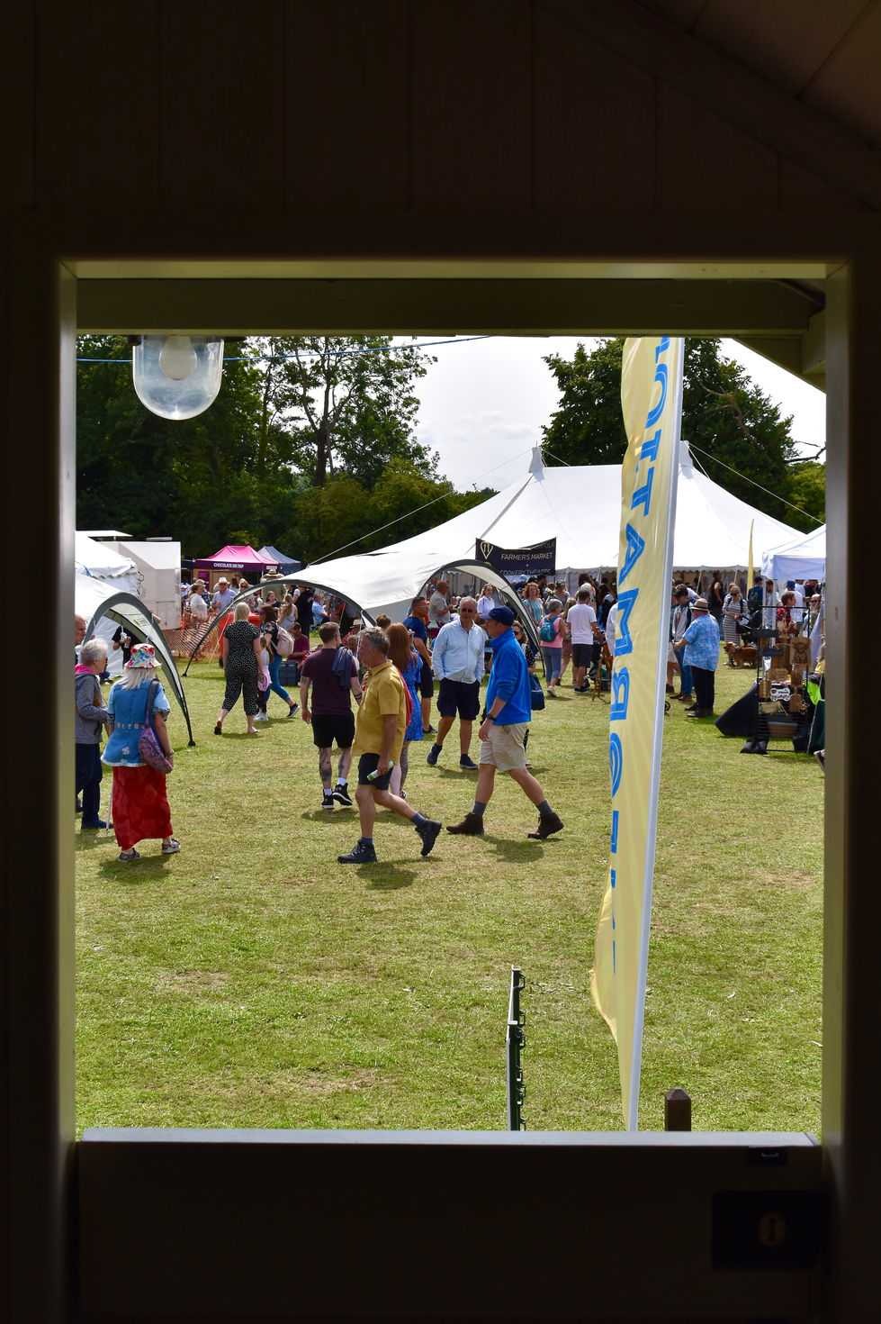 The festival customers through a Shepherd's Hut window - Worstead Festival