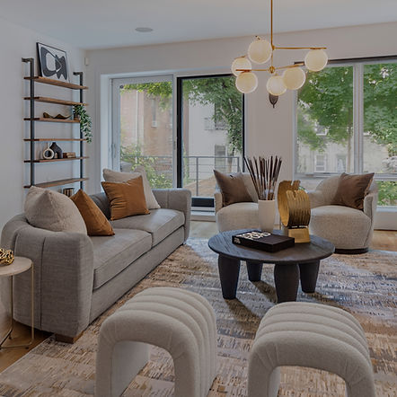 Modern living room with neutral-toned furniture, large windows, and contemporary decor.