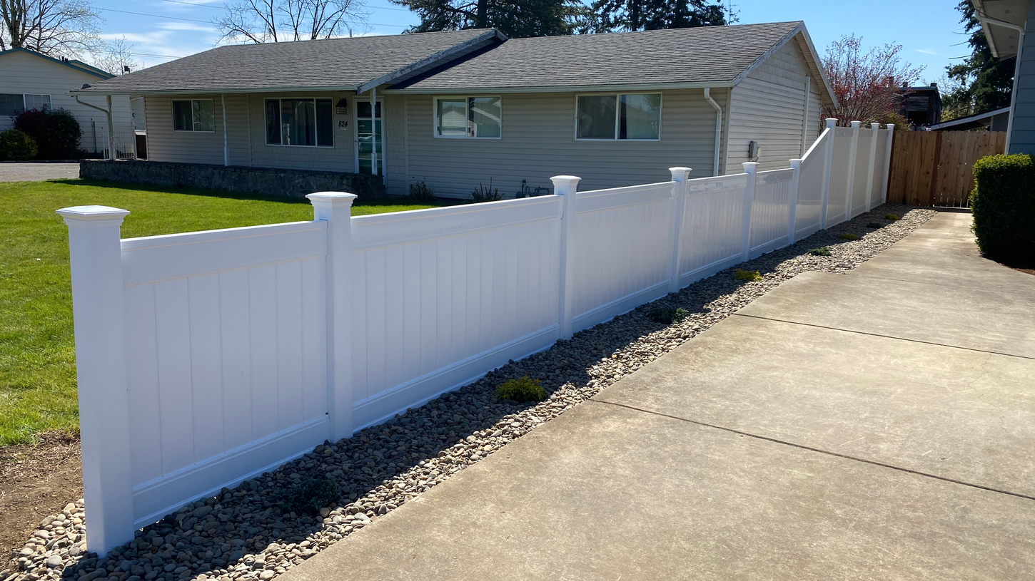 White vinyl fence installed along a driveway in Molalla Oregon
