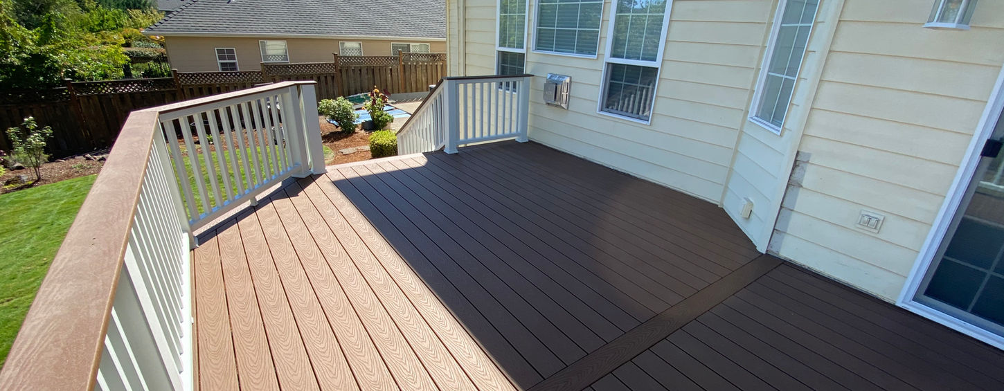 This custom elevated deck in West Salem features Trex® Select Saddle composite decking paired with a white Trex® cocktail railing system. Designed for low-maintenance outdoor living, the project provides a spacious outdoor entertaining area with long-lasting durability and timeless curb appeal.