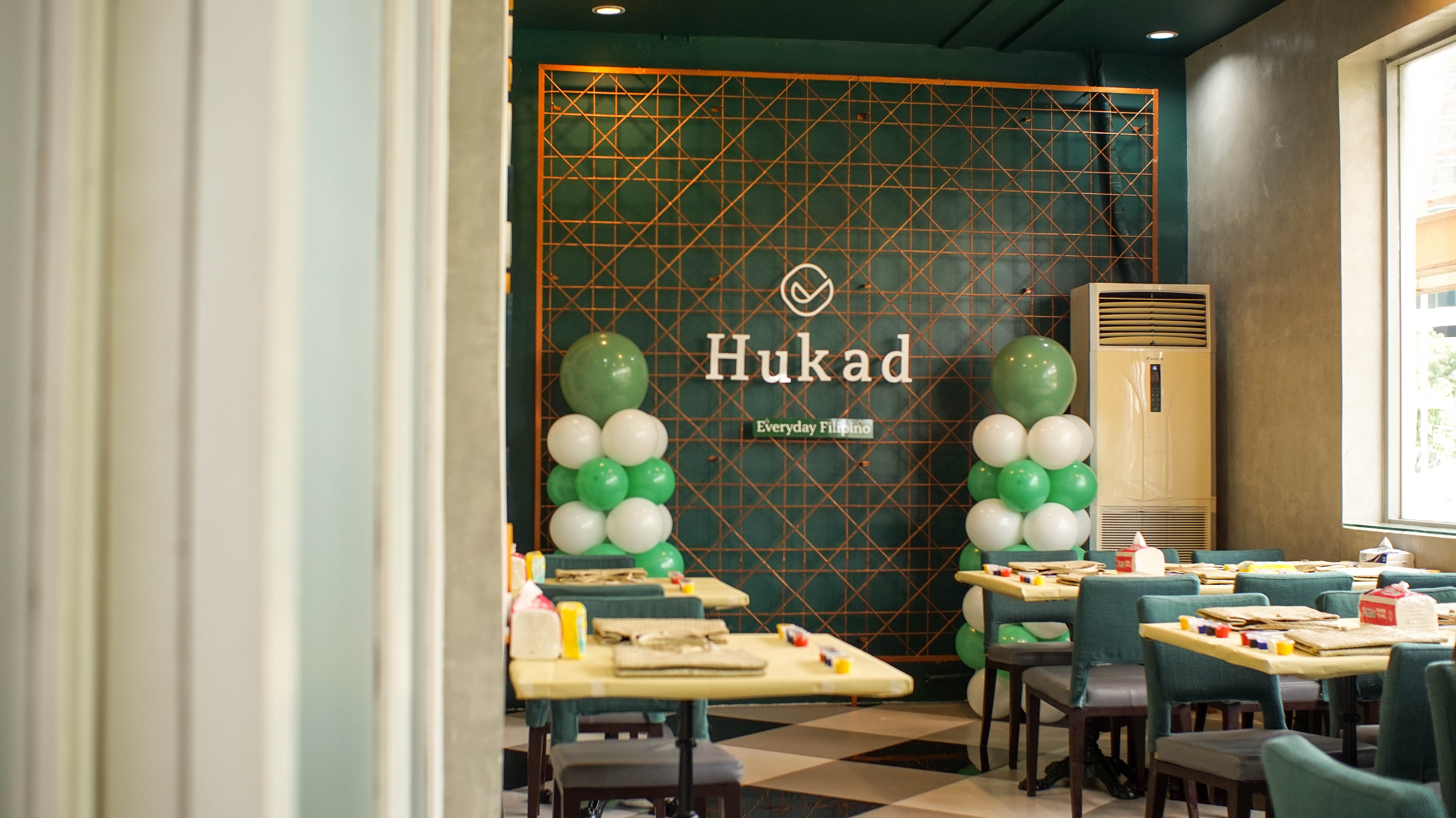 A warm Hukad restaurant interior
