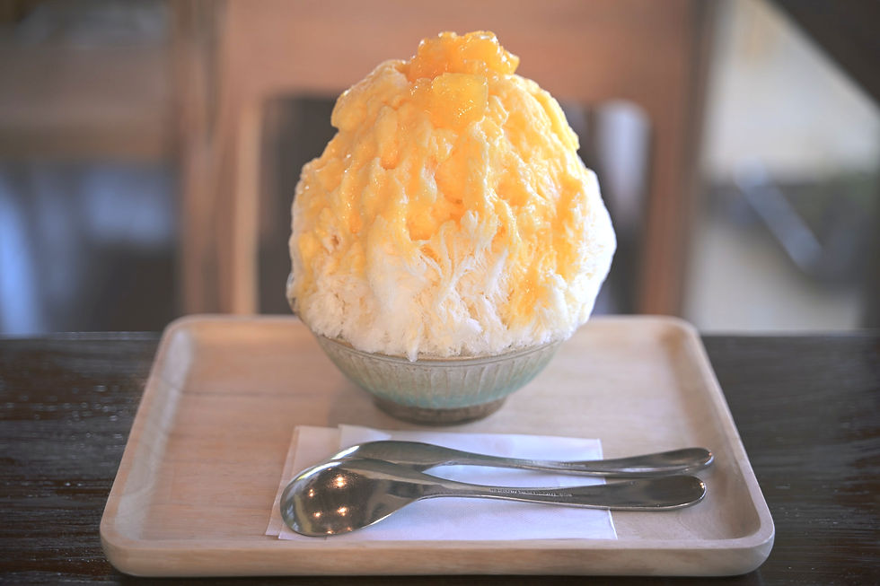 Fluffy shaved ice topped with mandarins and orange syrup.