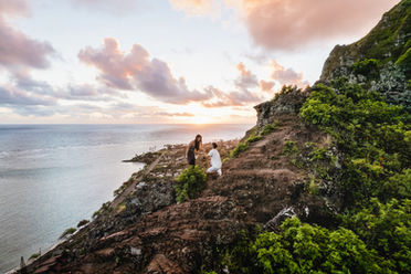 Exciting cliff-side proposal on Oahu during the couple's adventure session.