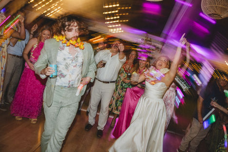 A bride and groom party during a reception moment at their Lanikuhonua Wedding on Oahu