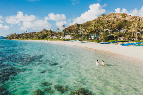Two expecting brides during a maternity beach session in Oahu, Hawaii
