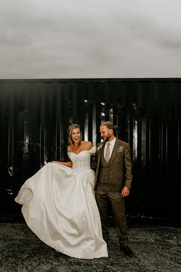 Jordan and Alexa smiling together in wedding attire.