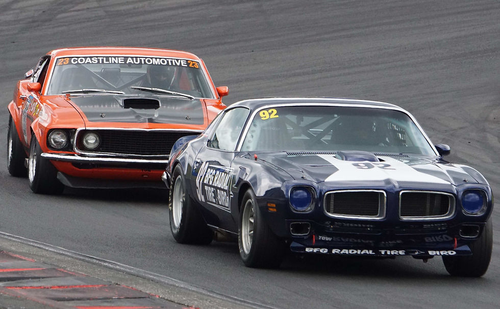 Two Muscle Cards racing on a track
