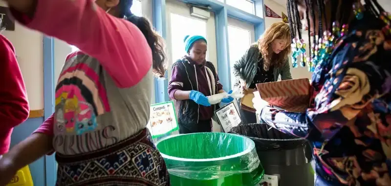 Nancy Deming and students sorting food into bins at Hoover Elementary in Oakland, California. Photo by Aaron Rosenblatt.