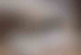 a living room with white furniture and a fireplace