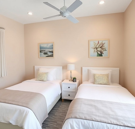 A small but modern and comfortable bedroom in Florida with two identical beds.jpg