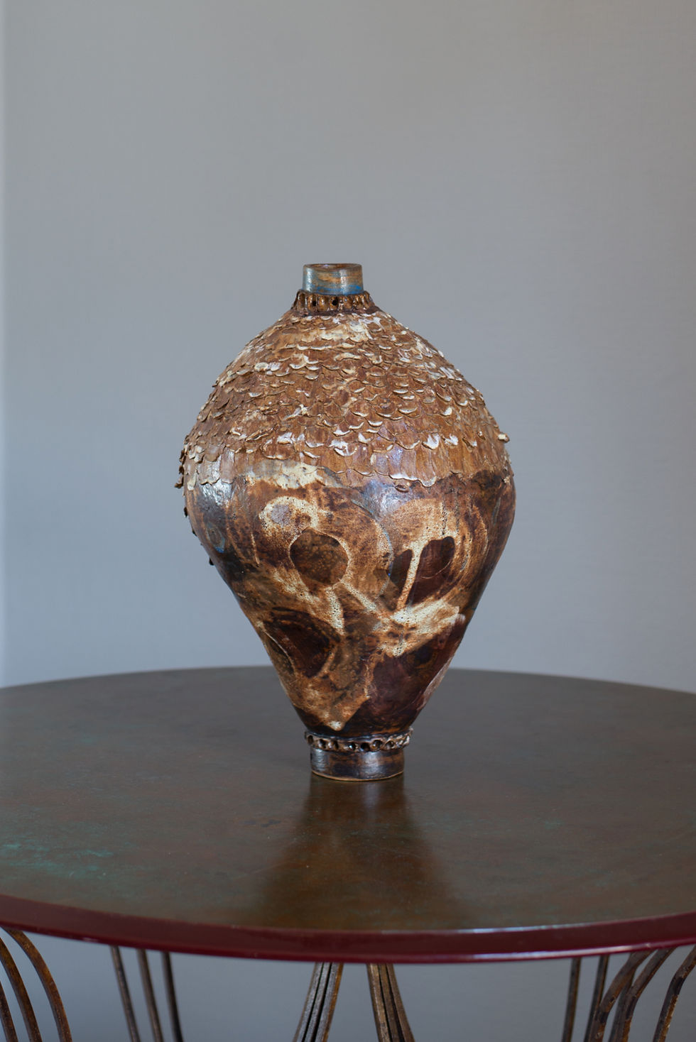 A stoneware sculptural vessel with glaze and stains by artist Linda Lencovic.