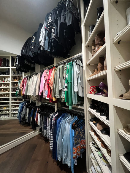 Women's clothing hanging in a three-story primary closet