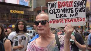 Black Lives Matter march white man holding placard
