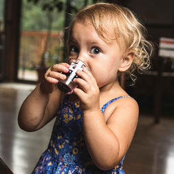 Child drinking American Elderberry Juice made by River Hills Harvest