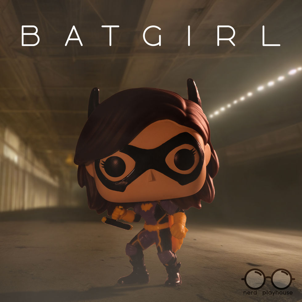 Creative toy photography of Funko POP Batgirl standing in a dark, smoky tunnel.