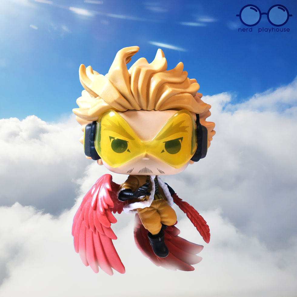 Creative toy photography of Funko POP Hawks flying above the clouds.