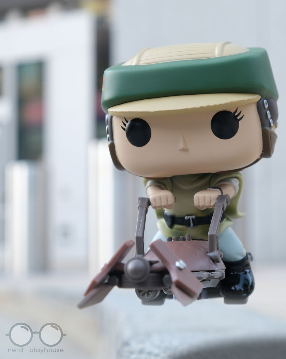 Creative toy photography of Funko POP Princess Leia on speeder bike, speeding to work.