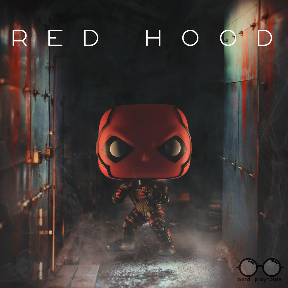 Creative toy photography of Funko POP Red Hood standing in a dark, wet hallway.